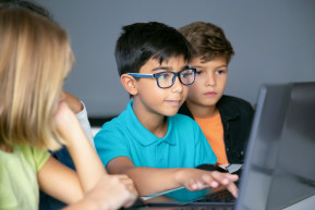 asian-boy-typing-laptop-keyboard-classmates-sitting-table-watching-him-doing-task-together_0