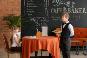 cute-little-waiter-serving-client-restaurant
