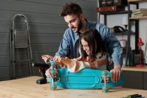 cute-smiling-girl-fixing-wheels-skateboard-while-young-man-helping-her_0